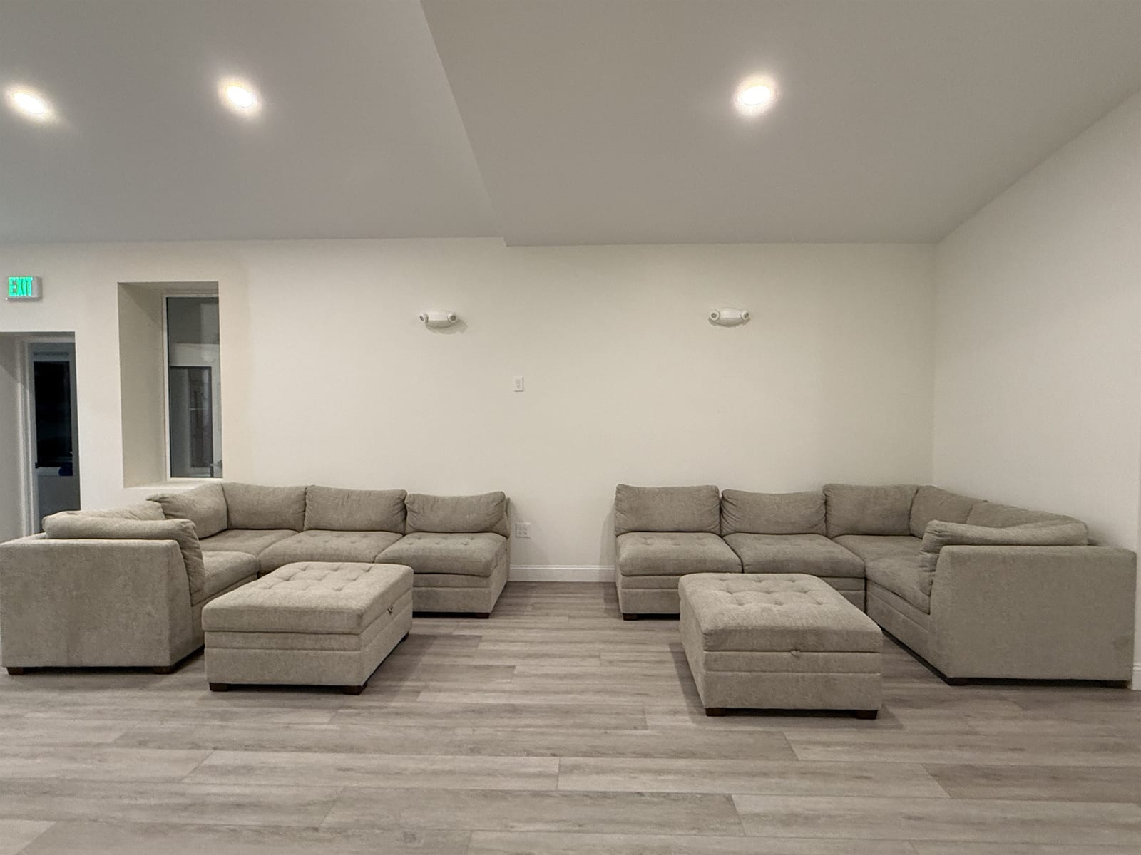 Family lounge at the Midway Blvd location with two large sectional sofas and ottomans