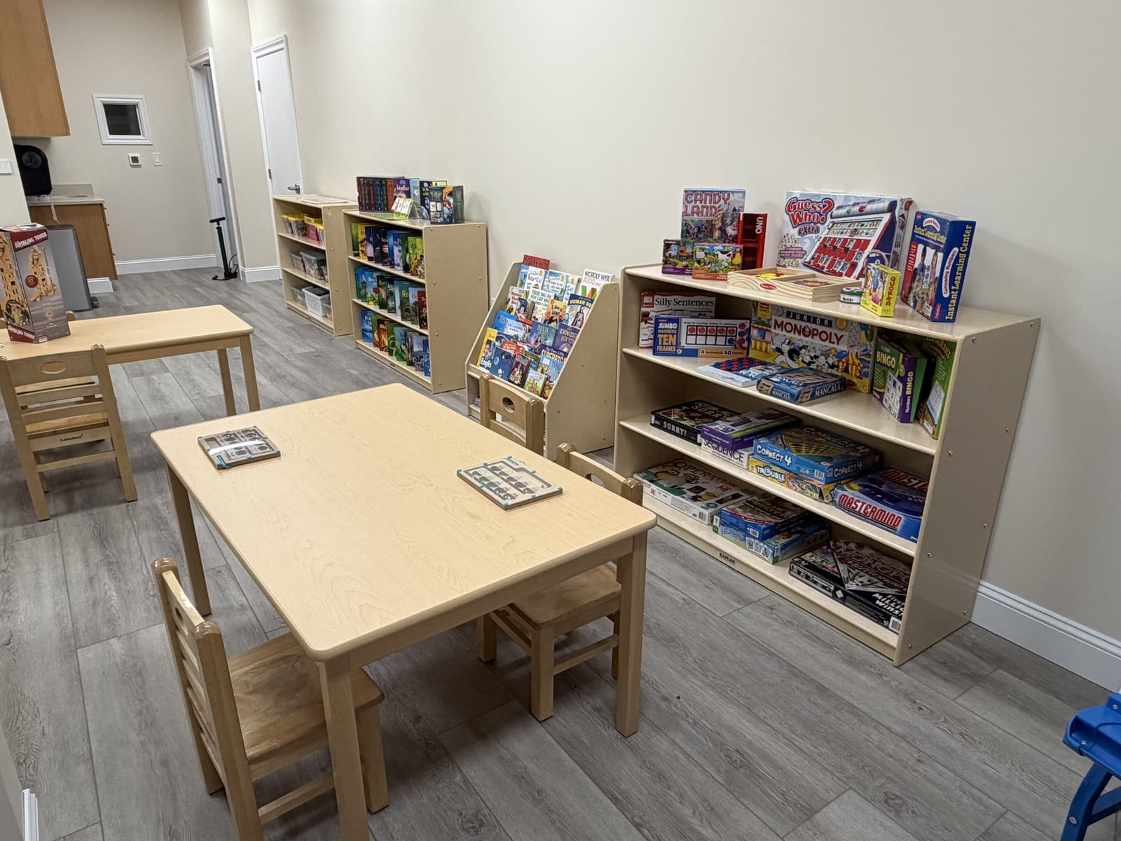 School-age area with shelves of board games, books, and a work table