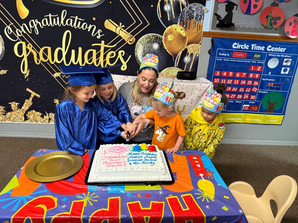 Preschool graduation cake cutting celebration